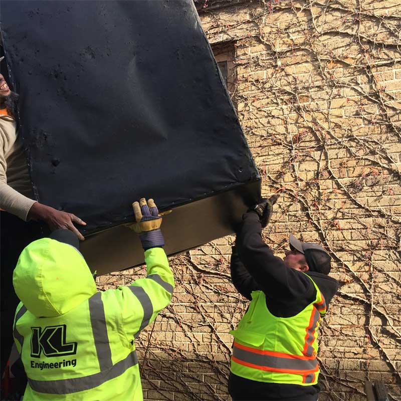 KL Engineering employees helping move a couch