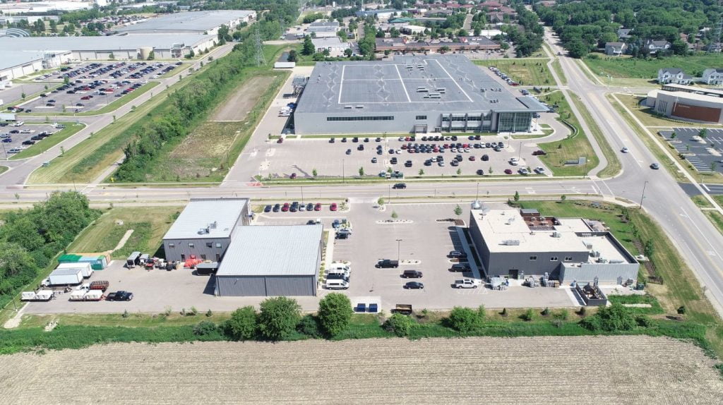 Aerial image of the finished Dunn Property area showing buildings and cars and parking lots where once there was only green fields.