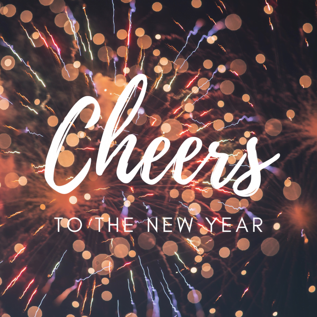 Cheers to the New Year greeting over fireworks
