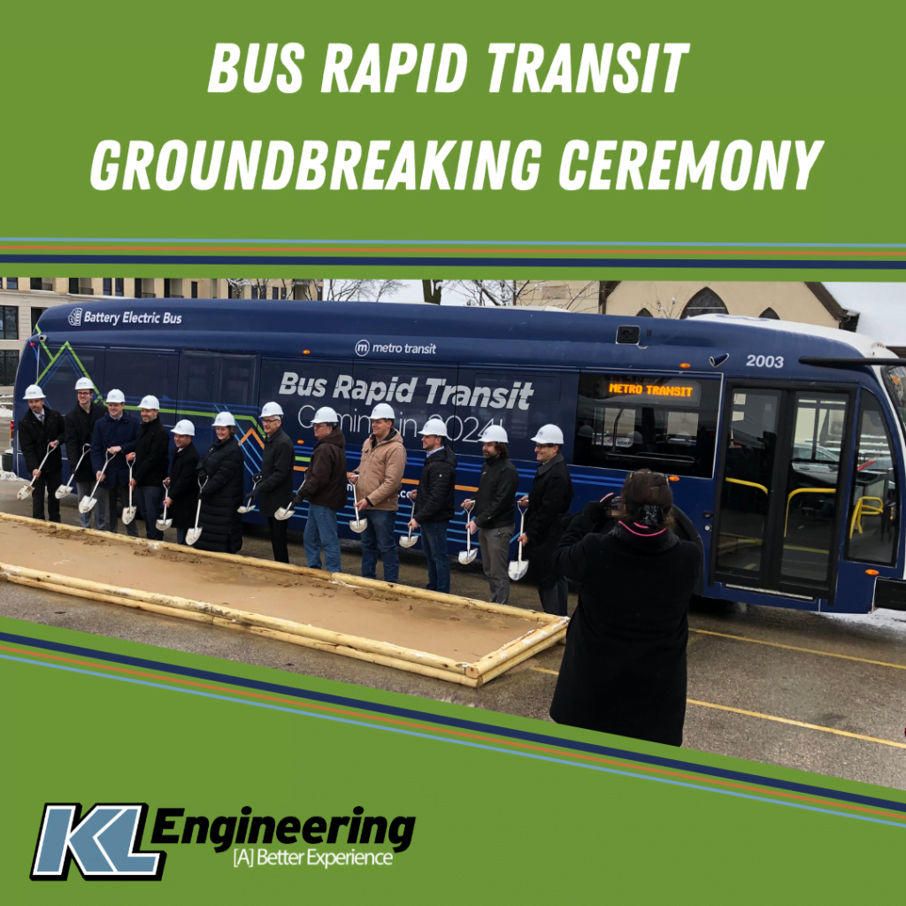 Photo of key project players posed with shovels in front of a bus.