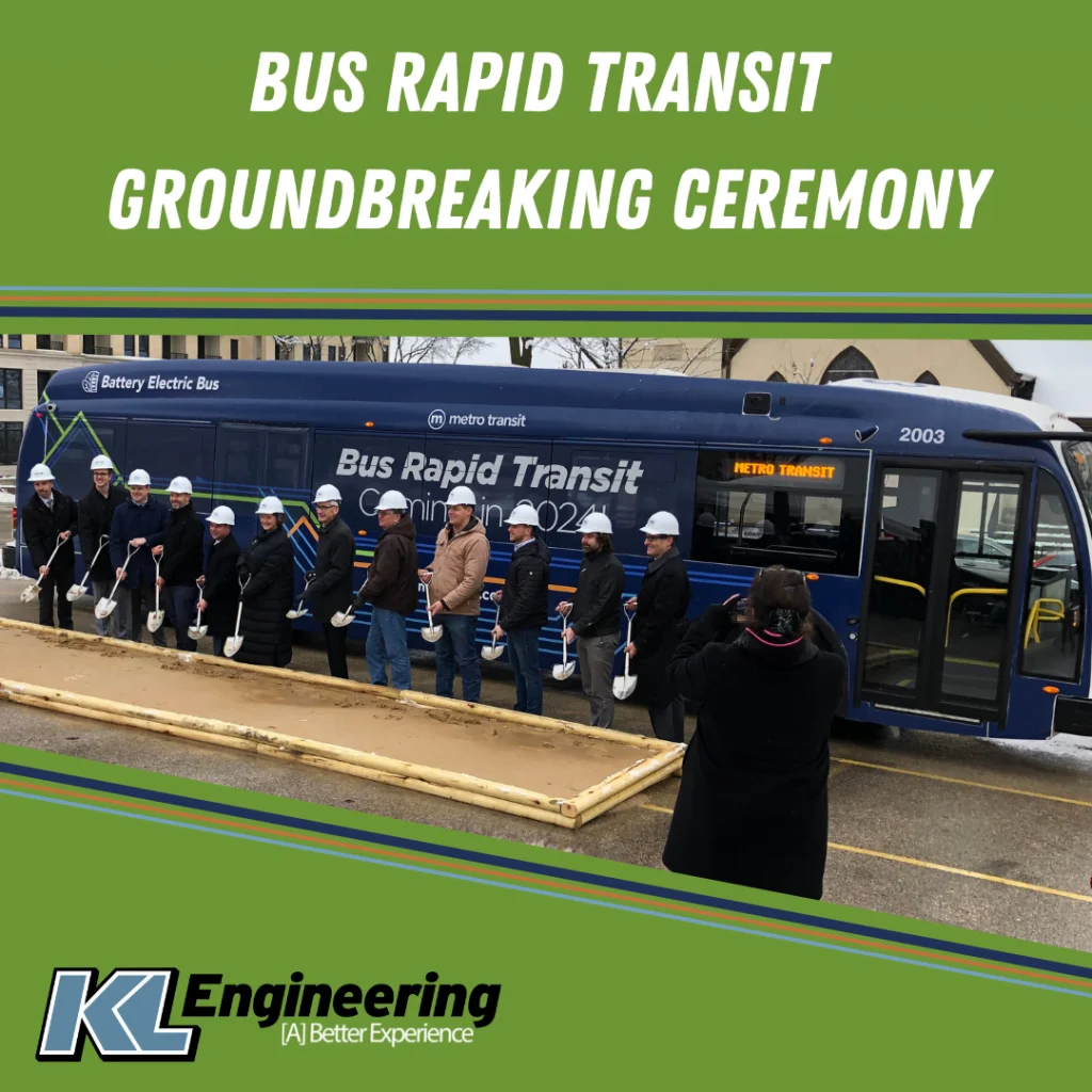 Photo of key project players posed with shovels in front of a bus.