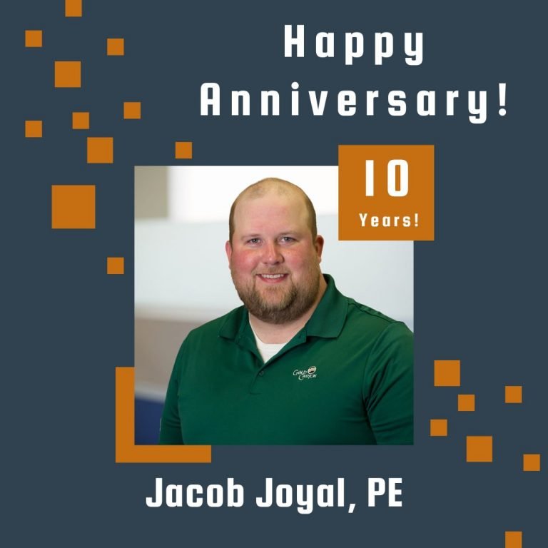 Photo of Jake Joyal framed by a navy background with orange scattered boxes and Happy Anniversary text.