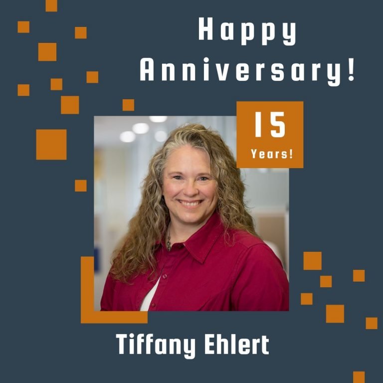 Photo of Tiffany Ehlert framed by a navy background with orange scattered boxes and Happy Anniversary text.