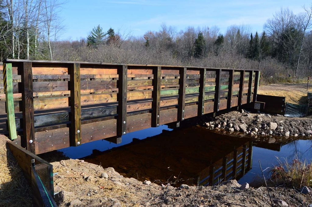 Connors Creek ATV Trail Bridge downstream face photo of side of bridge and stream below.