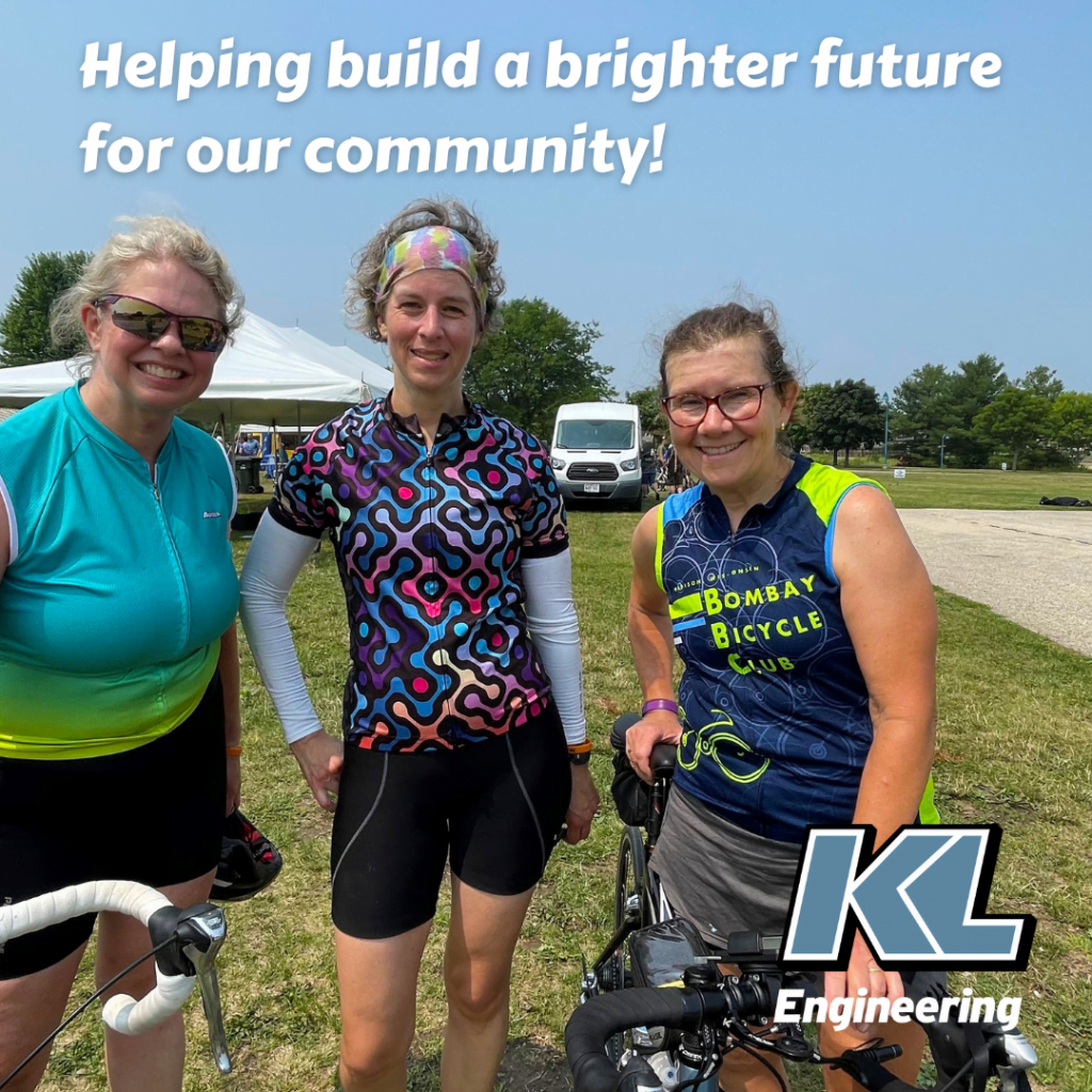 Helping build a brighter future for our community! Three women smiling along with bikes and bike helmets. KL Engineering logo.