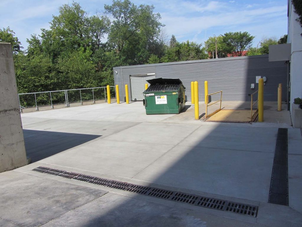 Kenilworth Receiving Area DFD project at UW-Milwaukee showing concrete area with green dumpster.