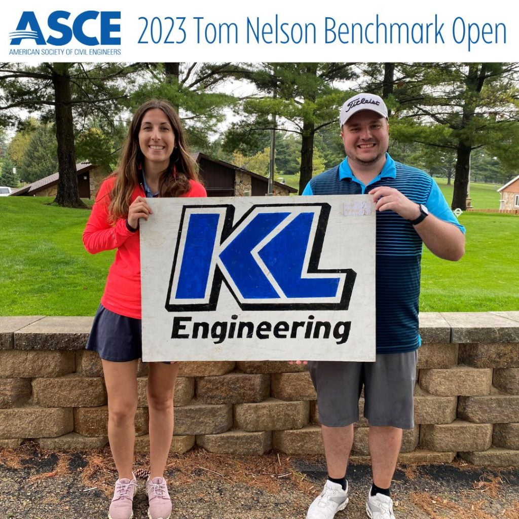 Photo of Arielle Lewien and Jared Baltes holding a KL Engineering sign at the sponsored golf hole for the event, with ASCE logo and event title at top.