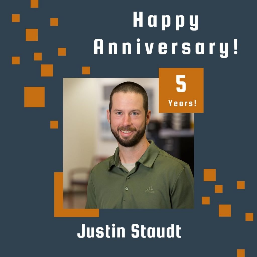 Photo of Justin Staudt framed by a navy background with orange scattered boxes and Happy Anniversary text.