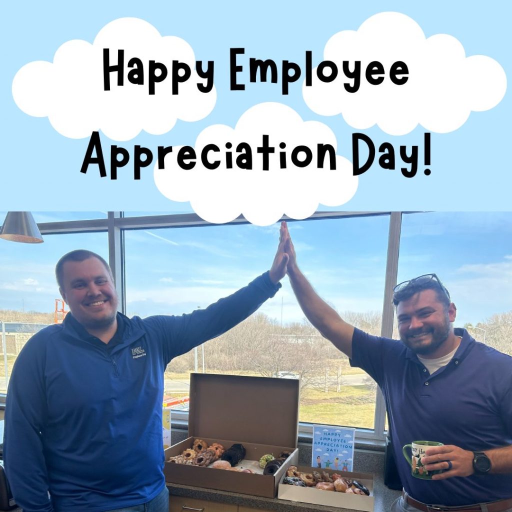 Photo of two employees giving each other a high five over a counter full of donuts, with a clouds graphic and 'Happy Employee Appreciation Day!' in black letters.