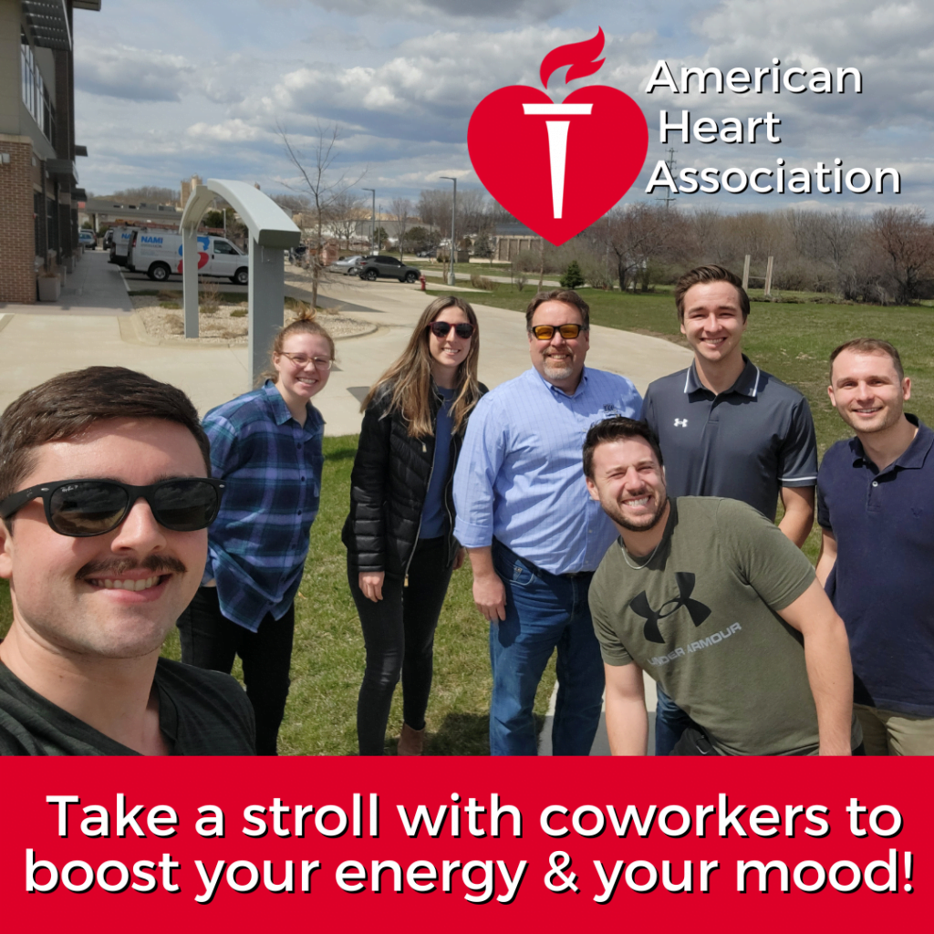 Photo of 7 KL employees before a lunchtime walk. 'Take a stroll with coworkers to boost your energy & mood' text and American Heart Association logo.