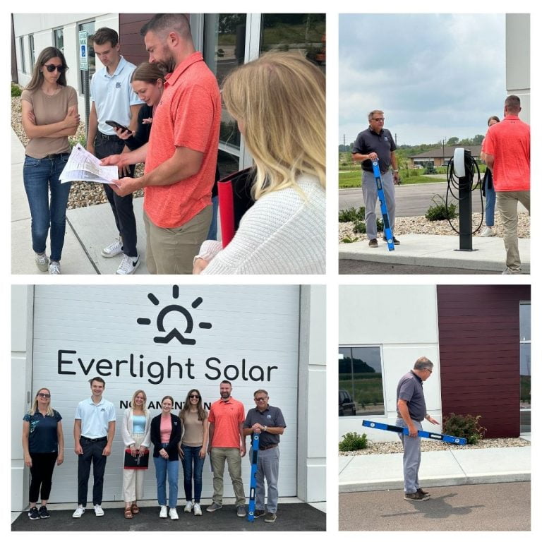 The graphic includes four photos from the visit, including people looking at a plan of the parking lot, near the electric vehicle charging stations, someone with a level gesturing to the sidewalk, and a group photo near the site's logo.