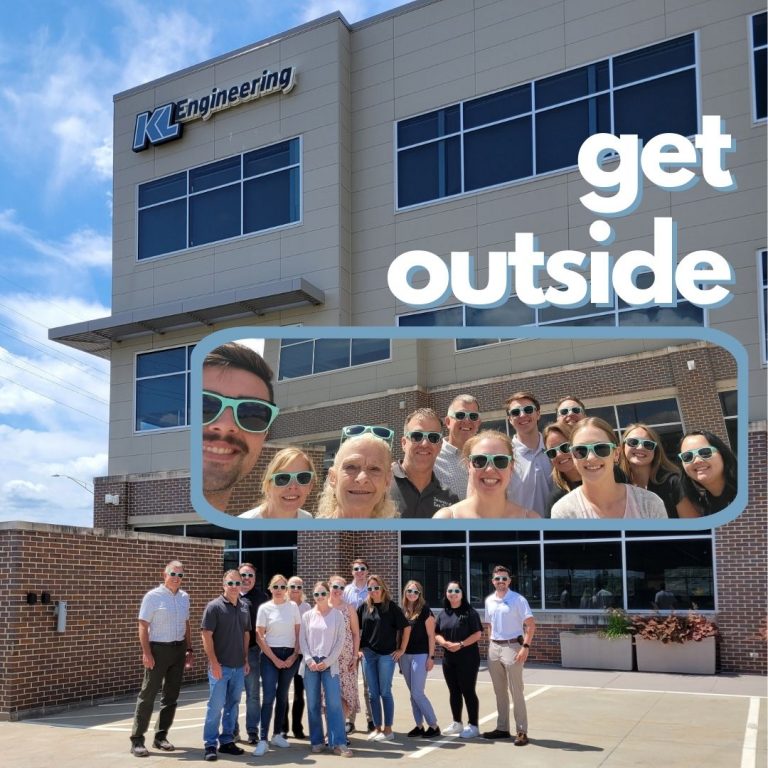 Photo of 11 people wearing sunglasses, gathered for a walk outside of the Madison KL office on a beautiful day.