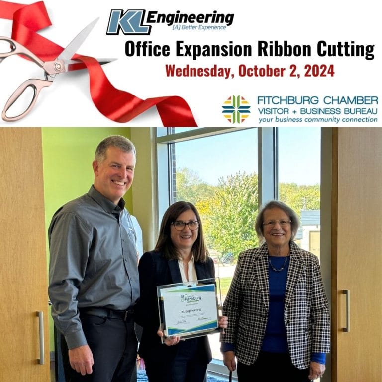 Photo of Scott, Julia, and Kim after the ribbon was cut with event logo at top.