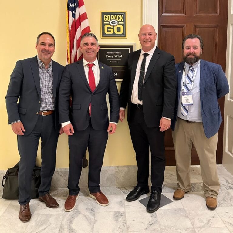 Photo of Ryan Schanhofer, Congressman Wied, and two others during their trip.