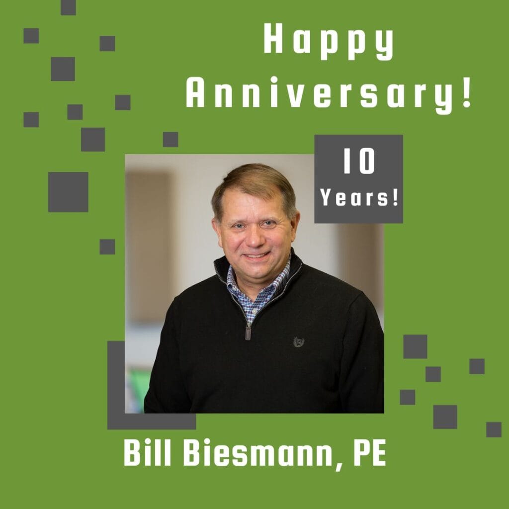 Photo of employee framed by a light green background with gray scattered boxes and Happy Anniversary text.