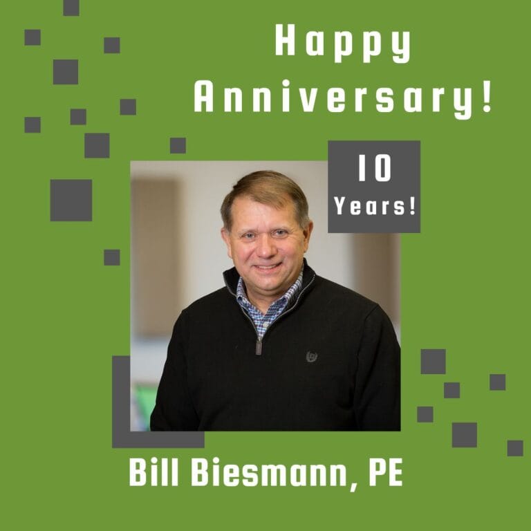 Photo of employee framed by a light green background with gray scattered boxes and Happy Anniversary text.