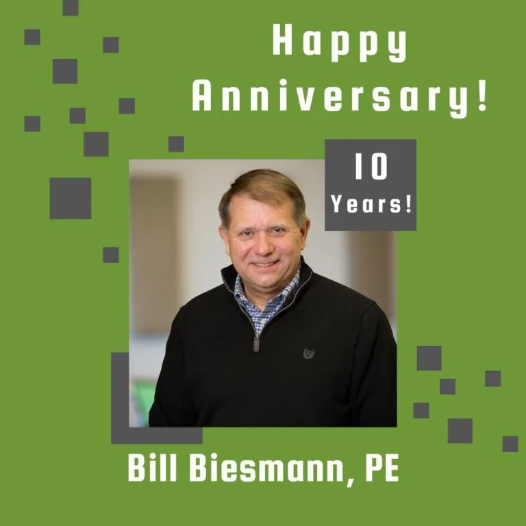 Photo of employee framed by a light green background with gray scattered boxes and Happy Anniversary text.