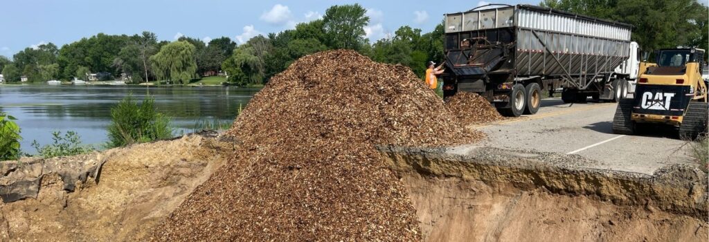 Photos of woodchips - the secret ingredient for this project - being dumped into the project site.