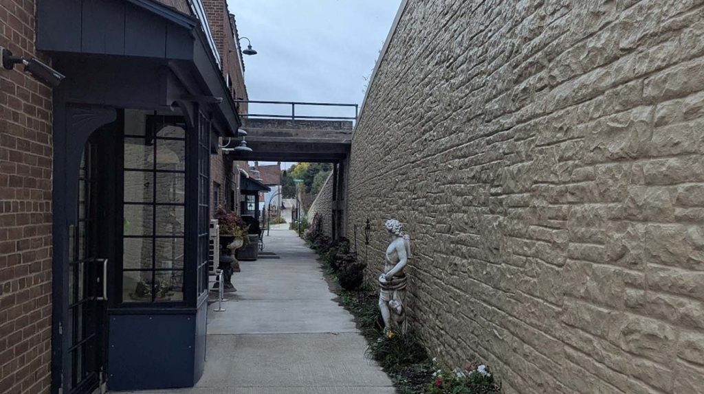 STH 35 Retaining Wall project showing finished wall next to creamery with confined pathway