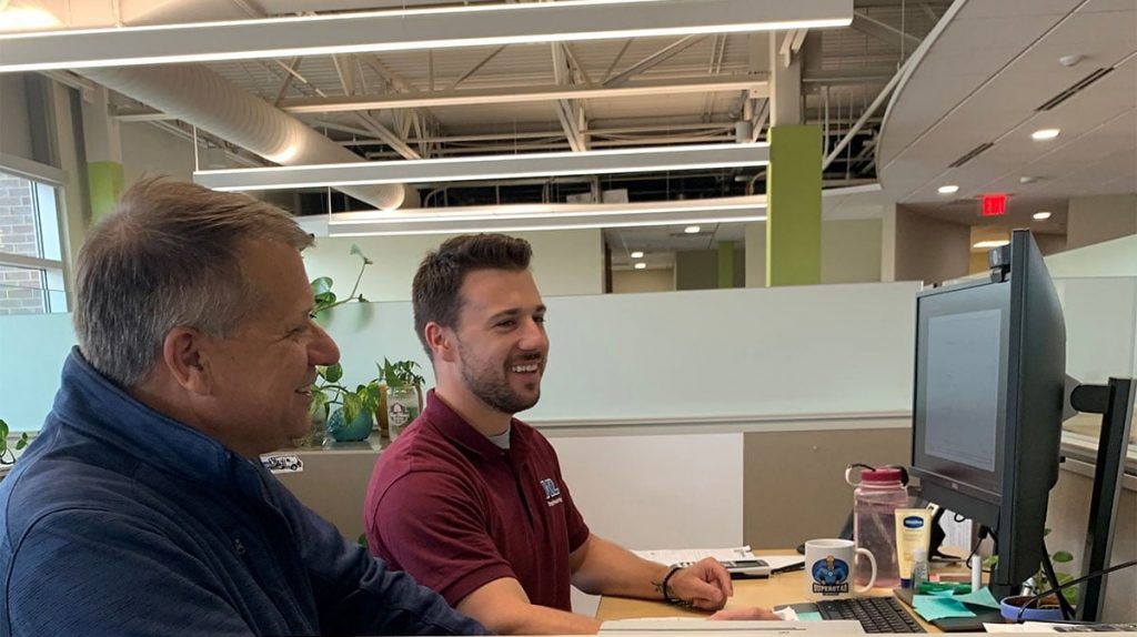 Cole-Bill-at-computer KL Engineering employees at a computer