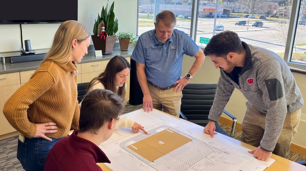 WS JD Photo_2016x1512-745kb Site Development Team looking at plans in a conference room