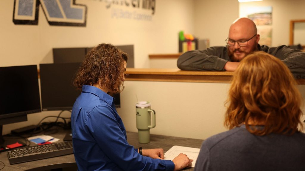 WS JD Photo_SrWtrRscEng2_2016x1512-745kb Three staff standing and looking at plans in our Menomonie office.