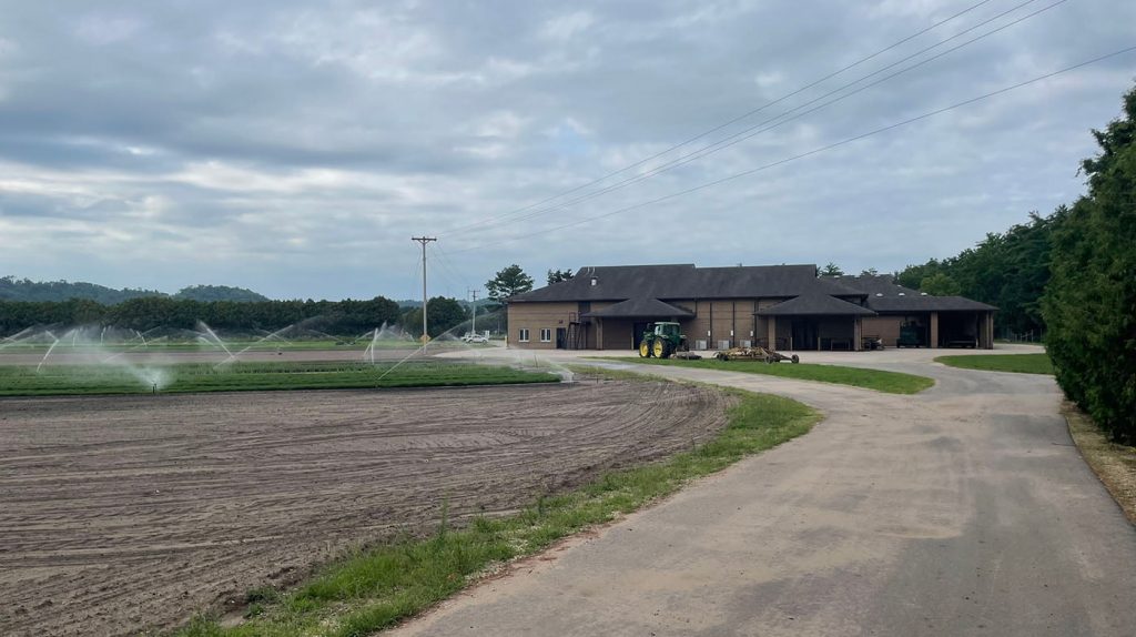 Wilson_1400_building-field_4331 Wilson Nursery with improved roadway showing building and field of plants with sprinkler system going.